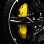 Detailed shot of a Chevrolet Corvette wheel rim with a bright yellow brake caliper.